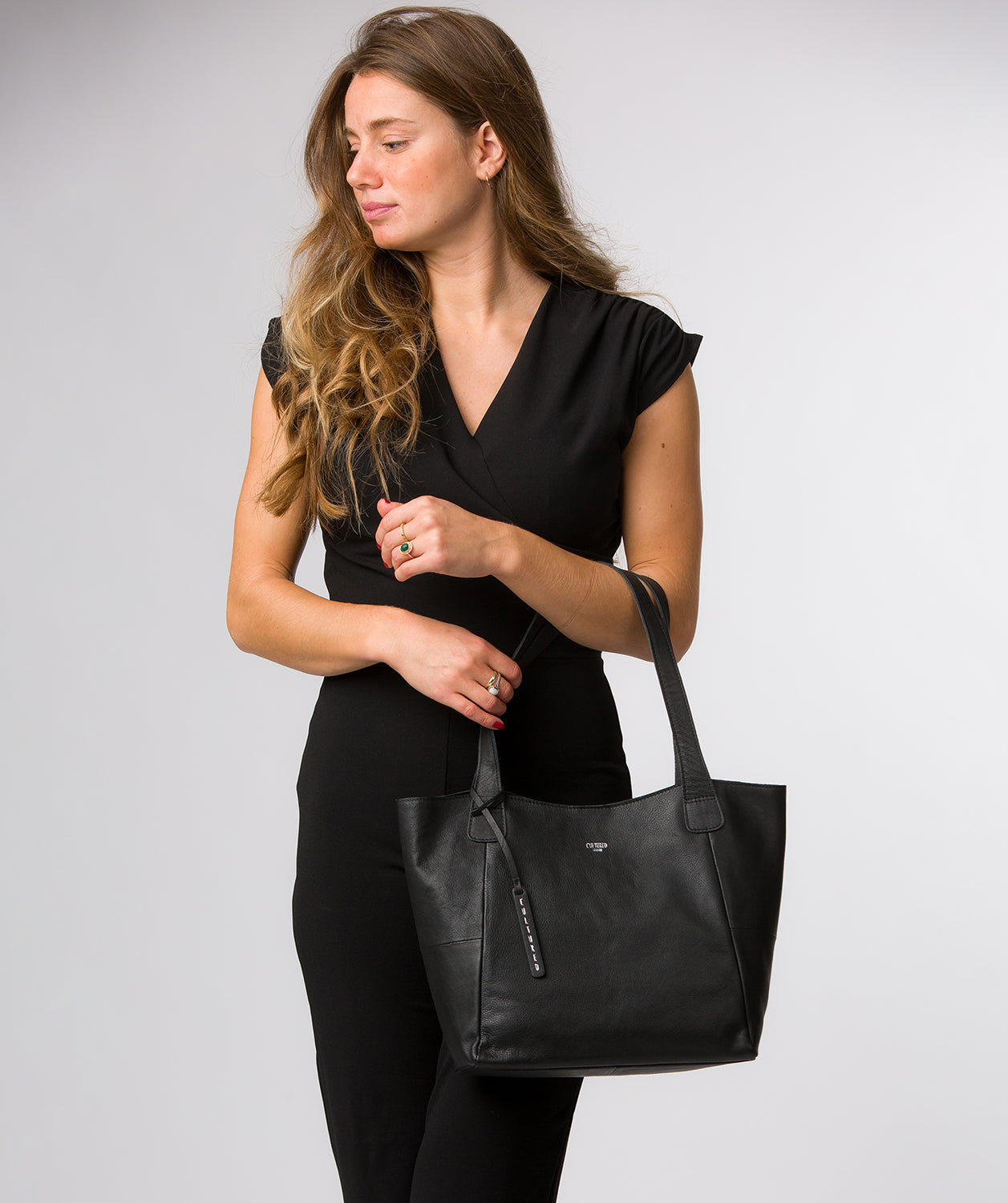 Back view of black leather tote bag