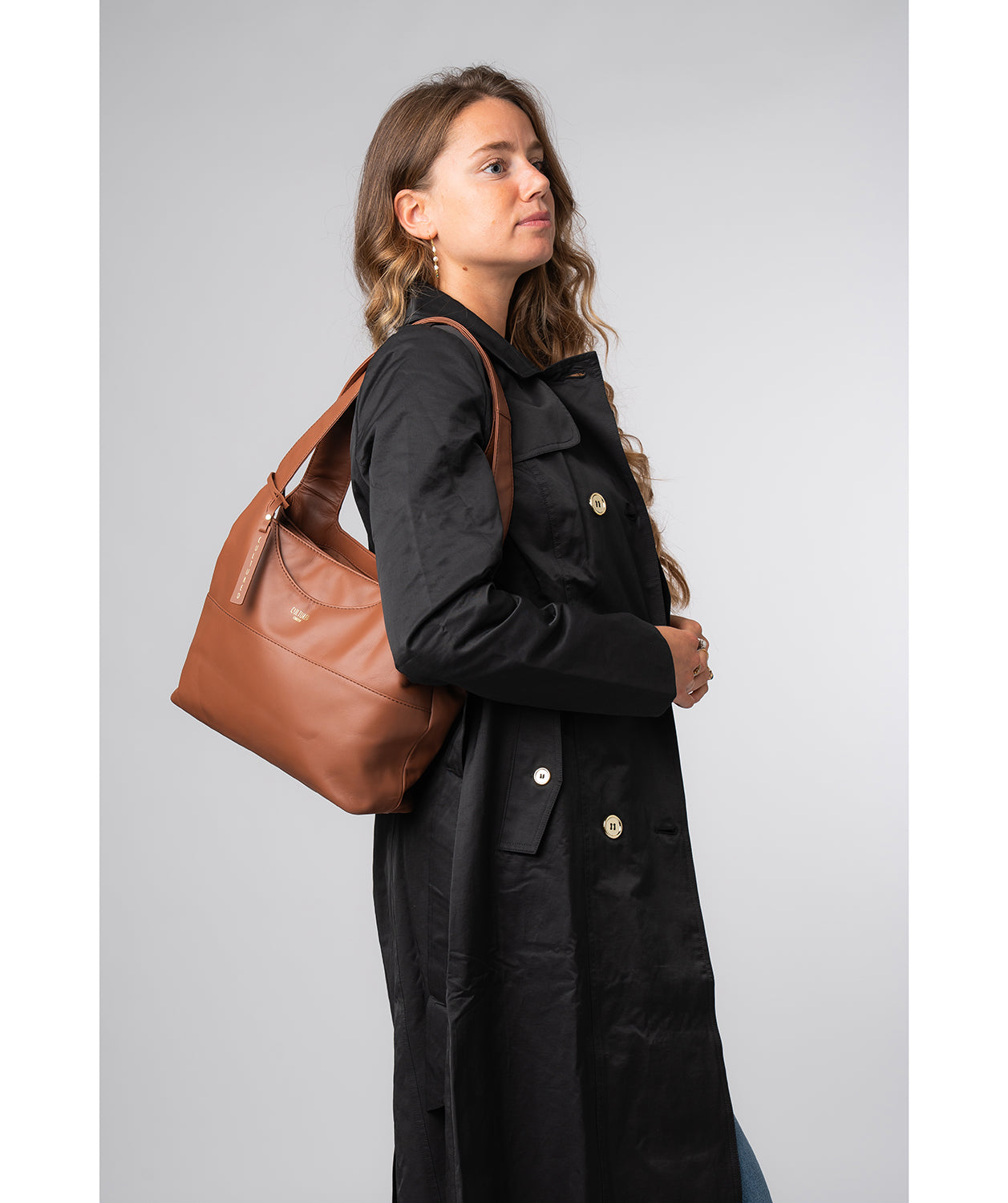 Back view showing structured silhouette and strap drop