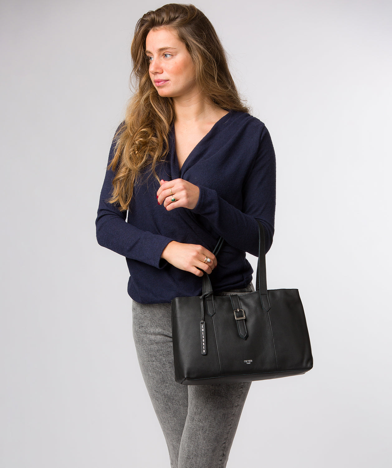 Noelle handbag side profile with mock buckle strap