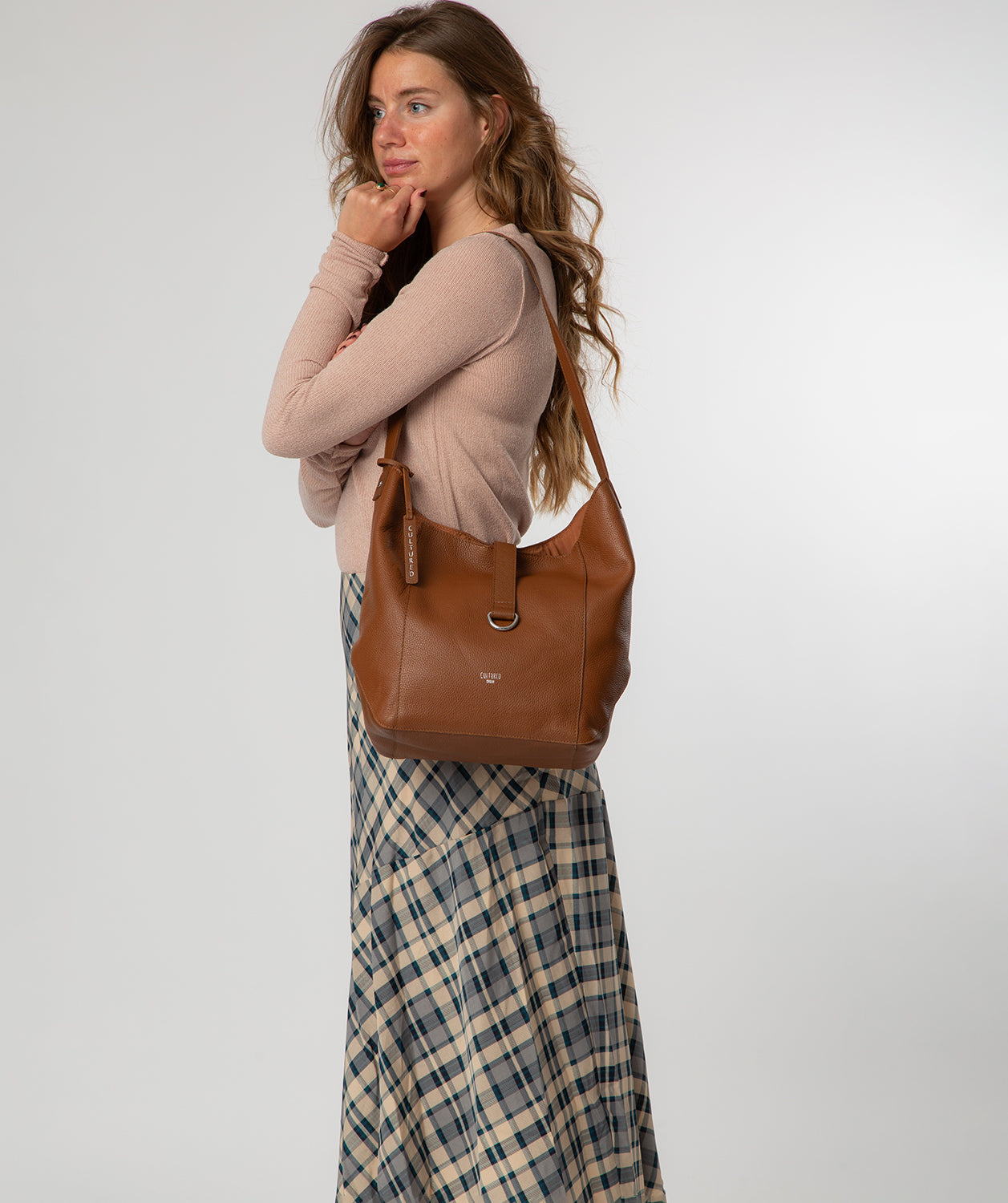 Leilani tan leather bag side profile with magnetic strap